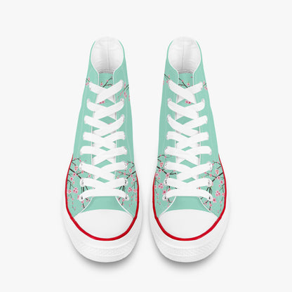 Pair of high-top sneakers with floral design on a light green background