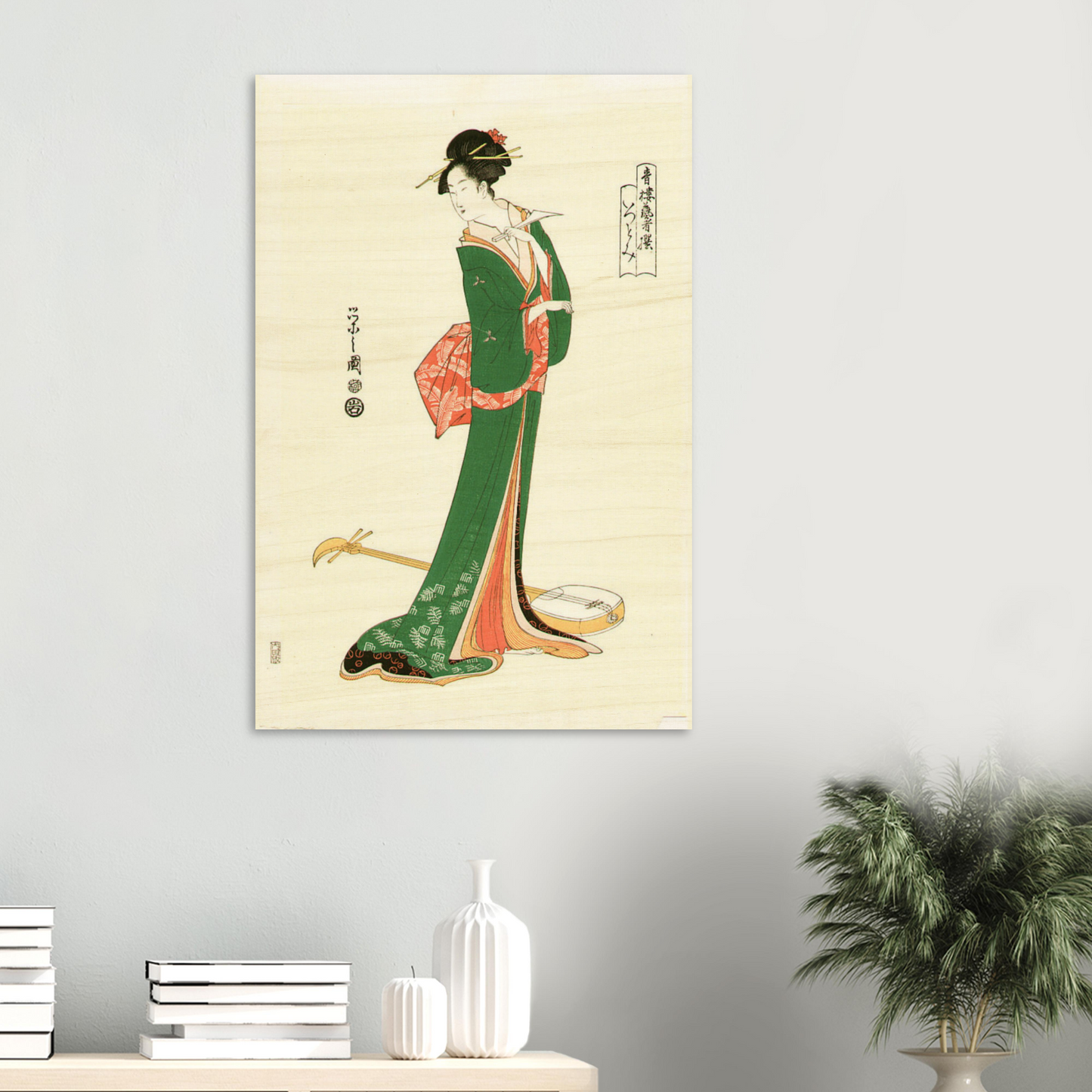 Traditional Japanese artwork of a woman in a green kimono on a beige background, displayed on a wall.