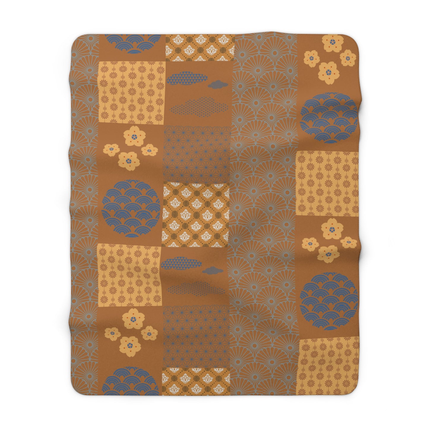 Patterned blanket with brown and blue design on a white background