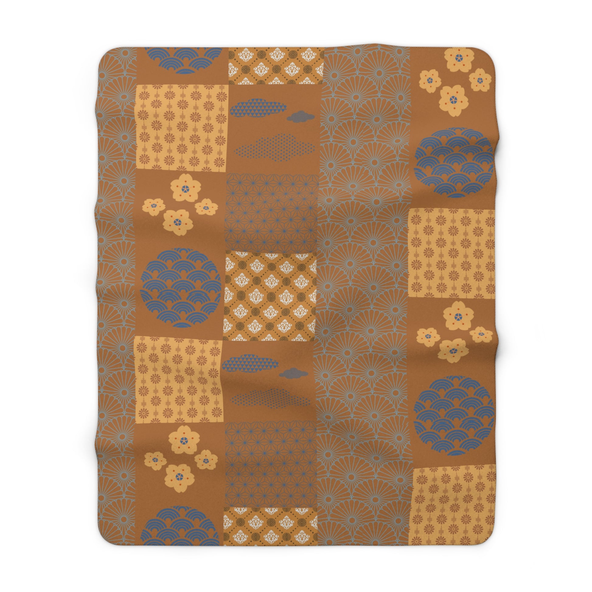 Patterned blanket with brown and blue design on a white background