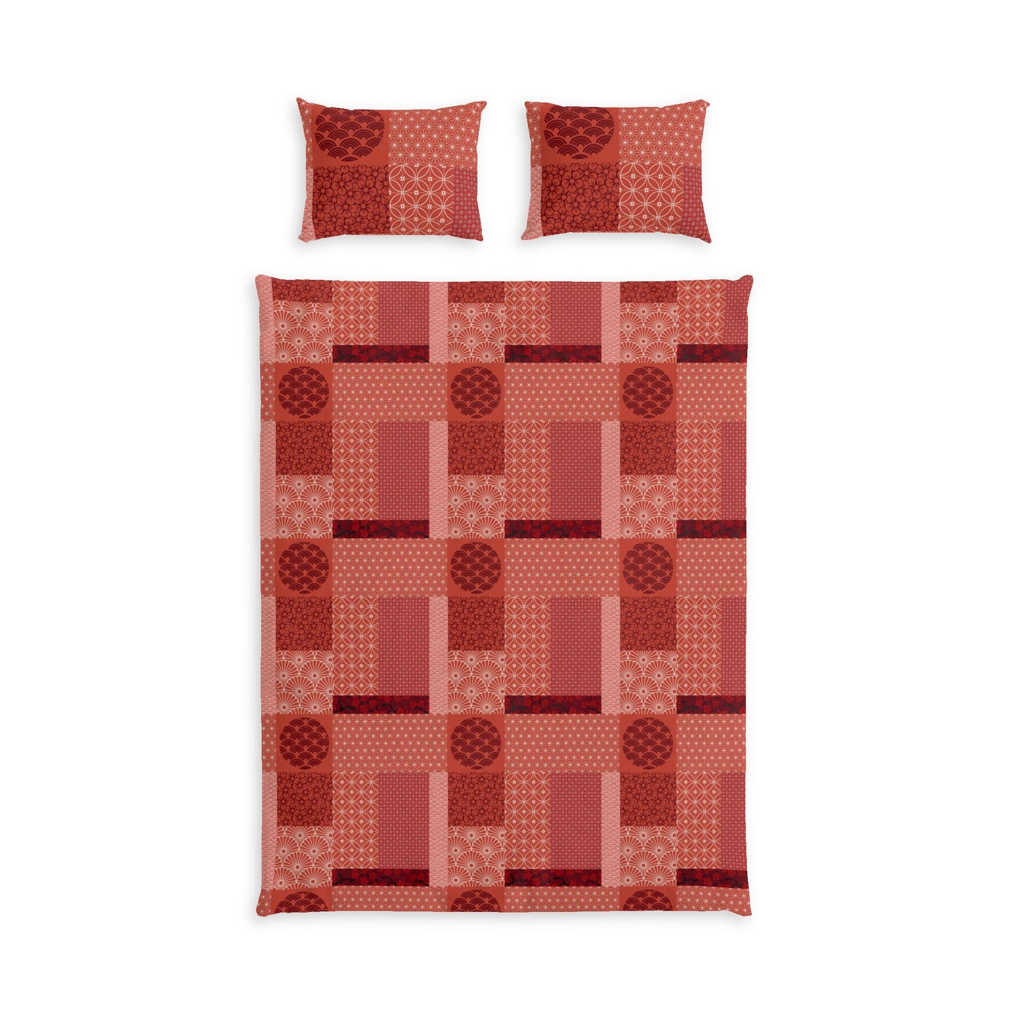 A bedding set featuring a patchwork quilt and two matching pillowcases in shades of red, terracotta, and pink with geometric and circular patterns, displayed on a solid white background.