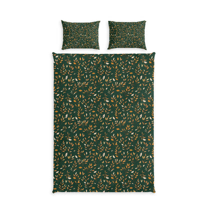 A bedding set featuring a dark green duvet cover and two matching pillowcases, all with a dense pattern of small leaves in mustard yellow and cream, displayed on a solid white background.