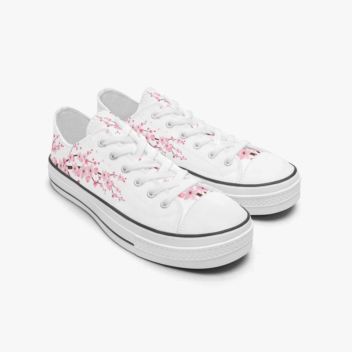 White sneakers with pink floral patterns on a white background