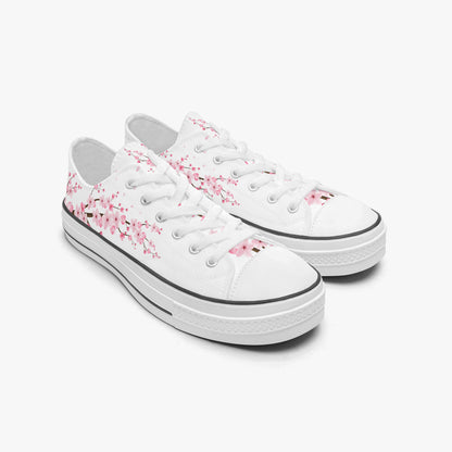 White sneakers with pink floral patterns on a white background