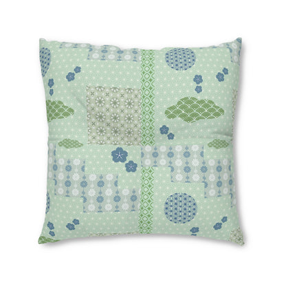 A square decorative throw pillow featuring a light mint green patchwork design with various Japanese-inspired patterns, including floral motifs, wave designs, and geometric borders in shades of green, blue, and white.