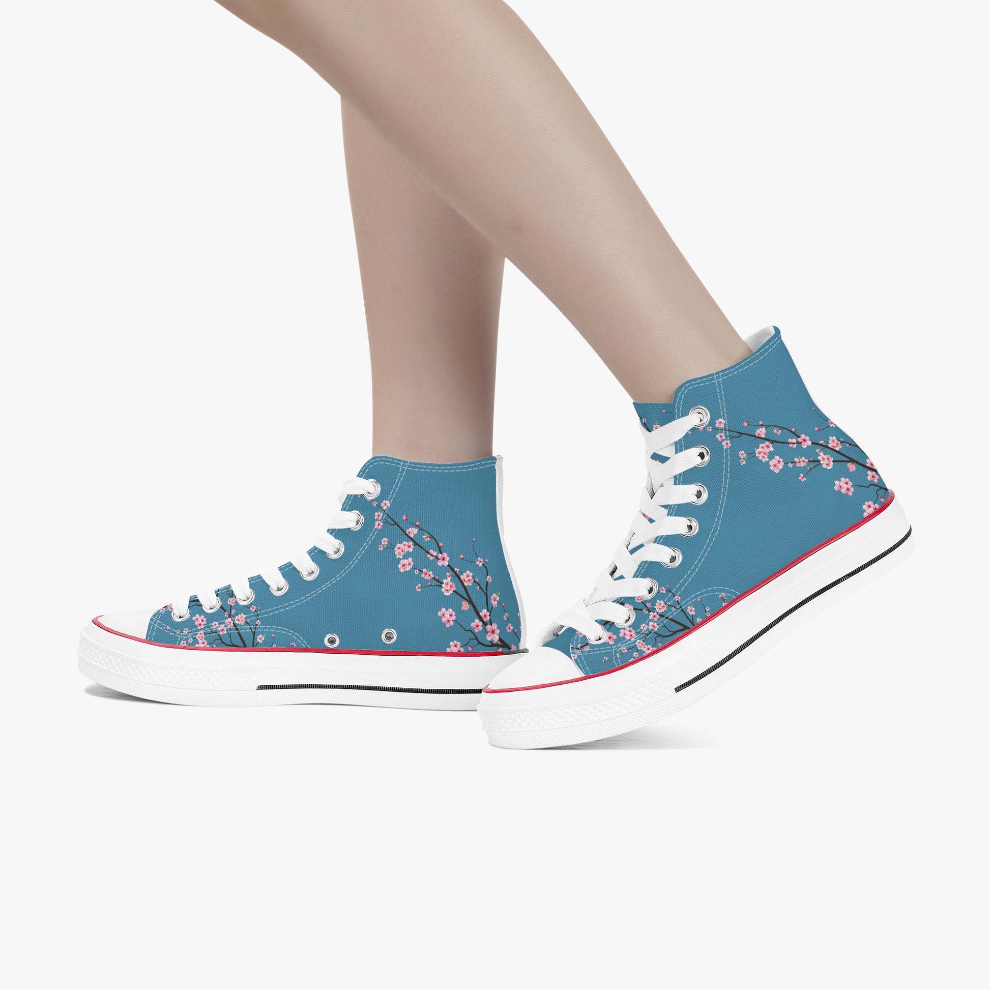 Blue high-top sneakers with floral design worn by a person on a white background