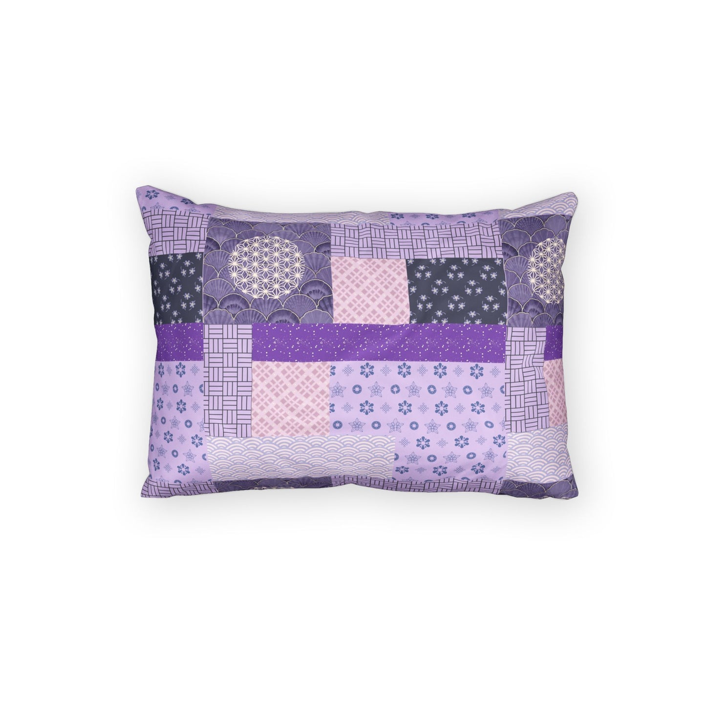A rectangular decorative pillow featuring a patchwork quilted design in shades of purple, lavender, and pink with various geometric and floral patterns, shown against a plain white background.