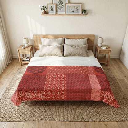 Bedroom with a bed featuring a red and white patterned duvet cover, wooden headboard, and side tables. Cotton Heritage