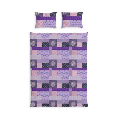A bedding set featuring a quilt and two matching pillowcases with a geometric patchwork design in shades of purple, pink, and dark gray on a white background.