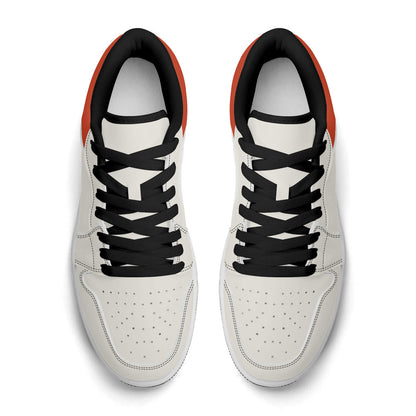 White sneakers with black laces on a white background