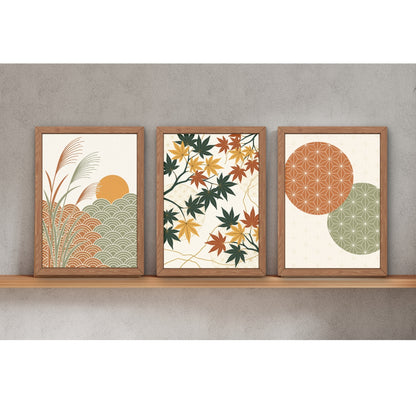 Three framed botanical and abstract art prints displayed side-by-side on a light wood shelf against a textured gray wall.