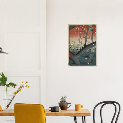 Framed artwork on a wall above a wooden table with chairs.