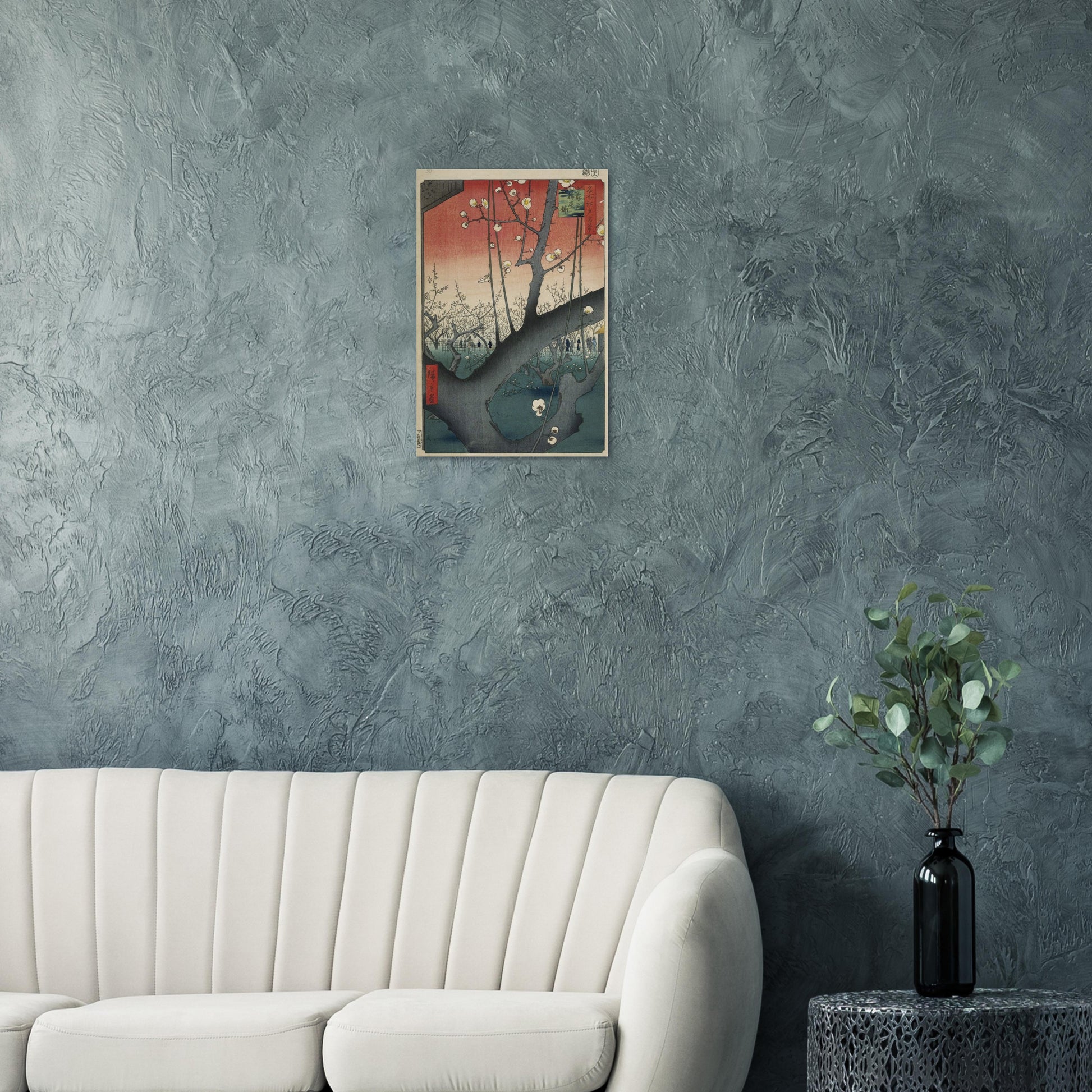 Wall art of a building on a textured gray wall above a white sofa.