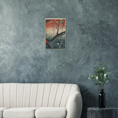 Wall art of a building on a textured gray wall above a white sofa.