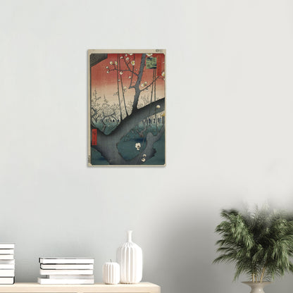 Framed artwork on a wall with books and a plant below