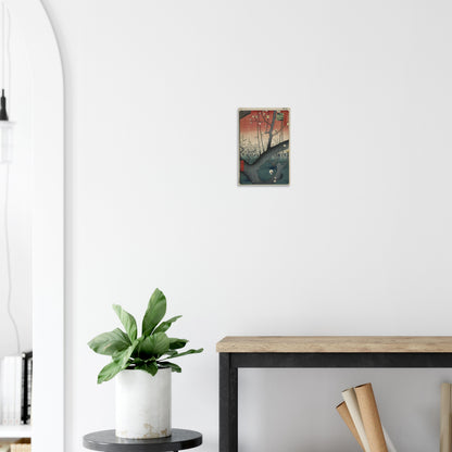 Colorful abstract art print on a white wall above a plant and desk.