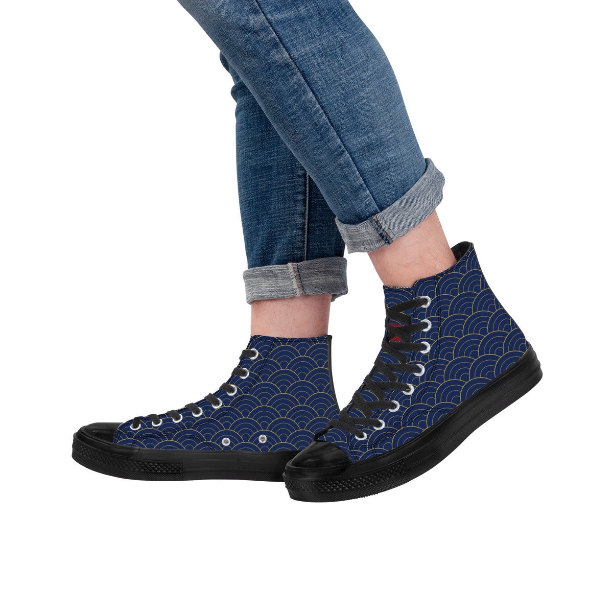 Blue high-top sneakers with black soles worn with rolled-up jeans on a white background