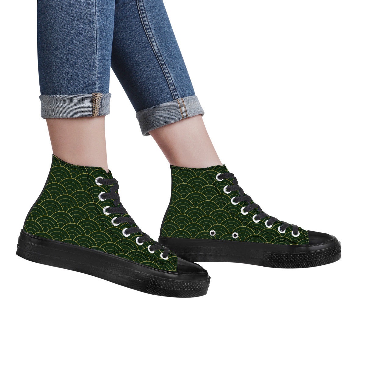 High-top sneakers with green pattern and black soles worn with rolled-up jeans on a white background