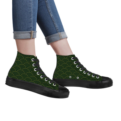 High-top sneakers with green pattern and black soles worn with rolled-up jeans on a white background
