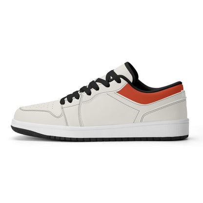 White sneaker with black and orange accents on a white background