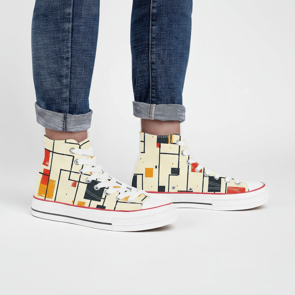 High-top sneakers with abstract pattern worn with rolled-up jeans on a white background