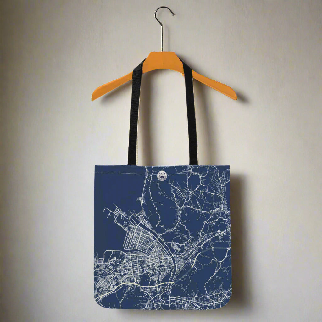 Tote bag with city map design on a hanger against a white background