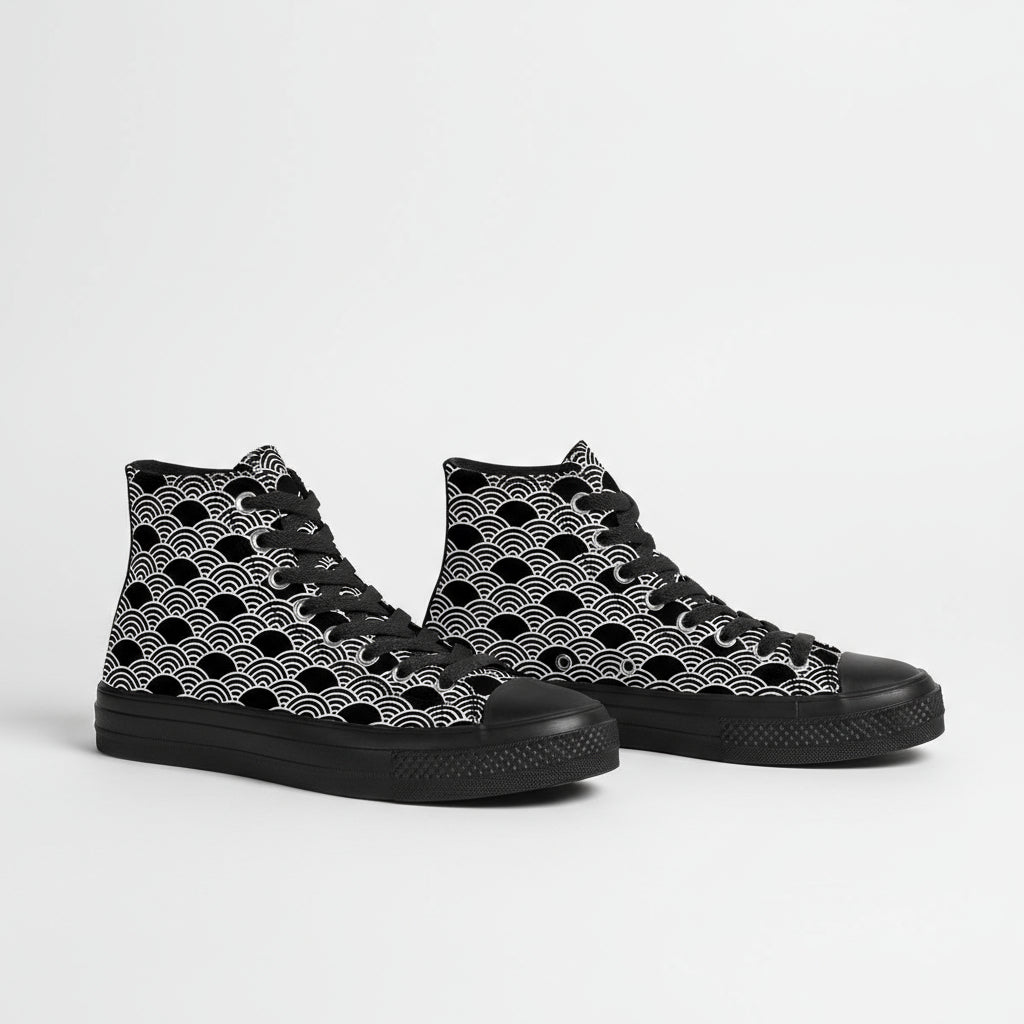 Black high-top sneakers with white wave pattern worn with rolled-up jeans on a white background