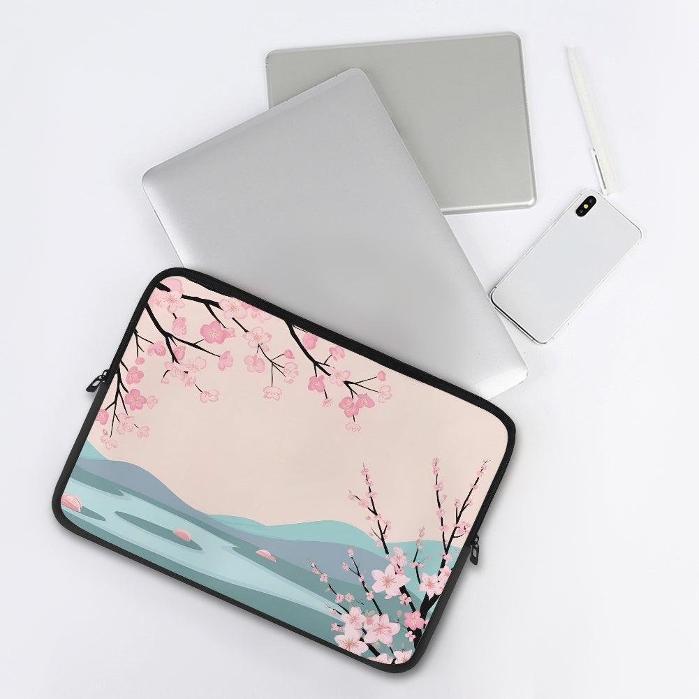 Laptop with cherry blossom design sleeve on a white background