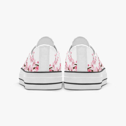 White sneakers with pink floral pattern on a white background