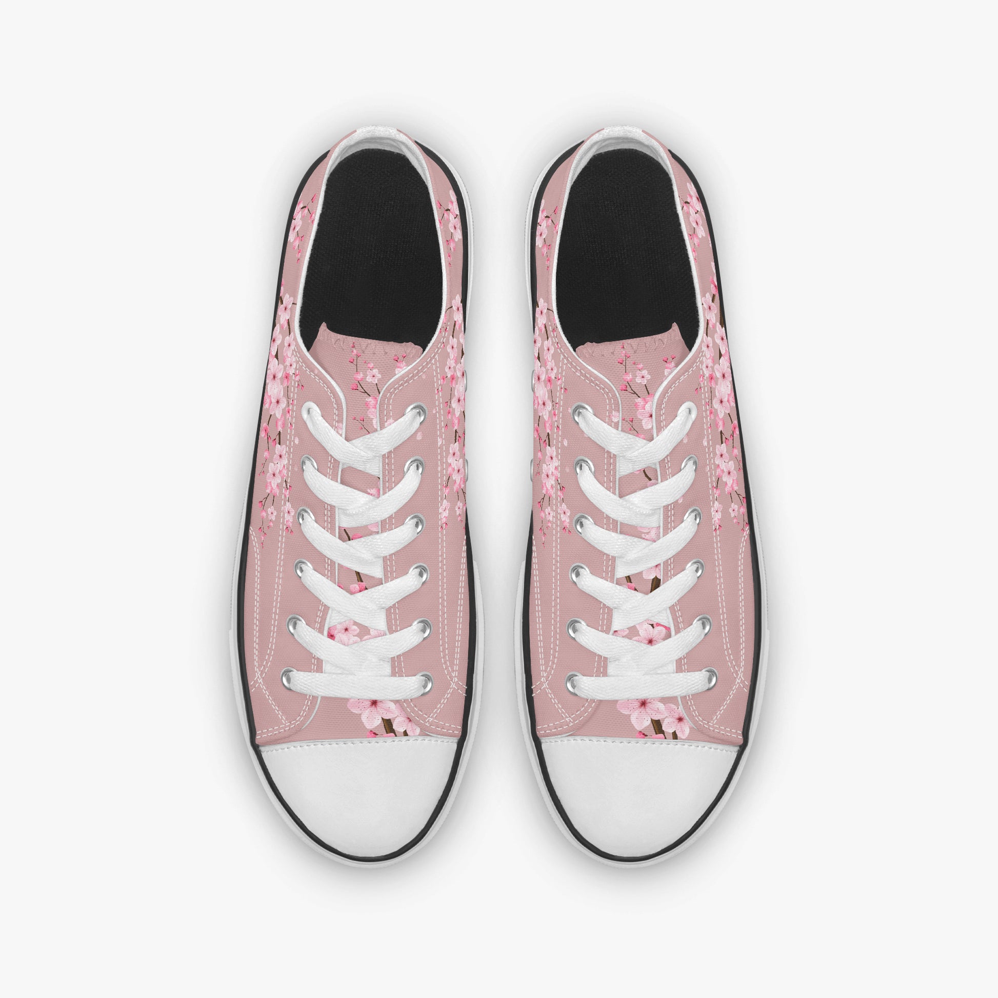 Pink floral sneakers with white laces on a white background