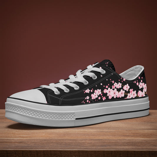 Black sneaker with pink floral design on a wooden surface and brown background