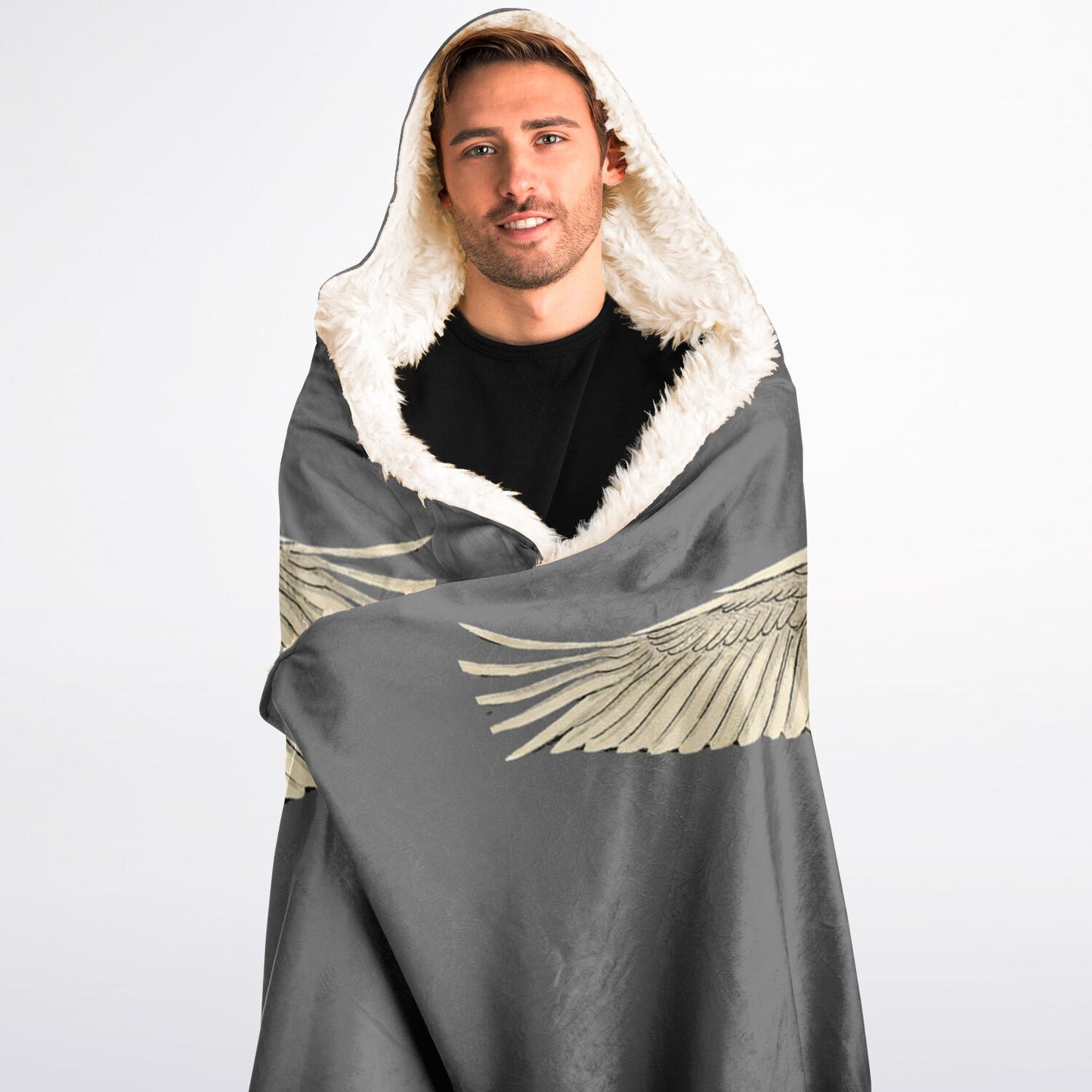 Man wrapped in a gray blanket with angel wings and white hood on a white background