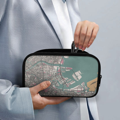 Person holding a small rectangular bag with a city map design on a light gray background