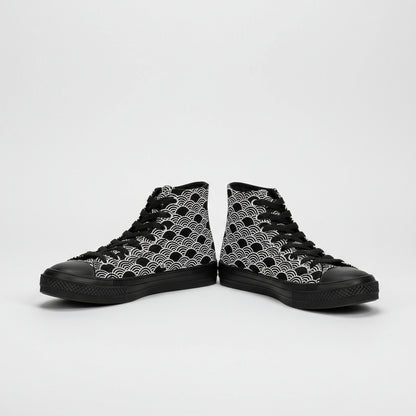 Black and white patterned high-top sneakers worn with rolled-up jeans on a white background