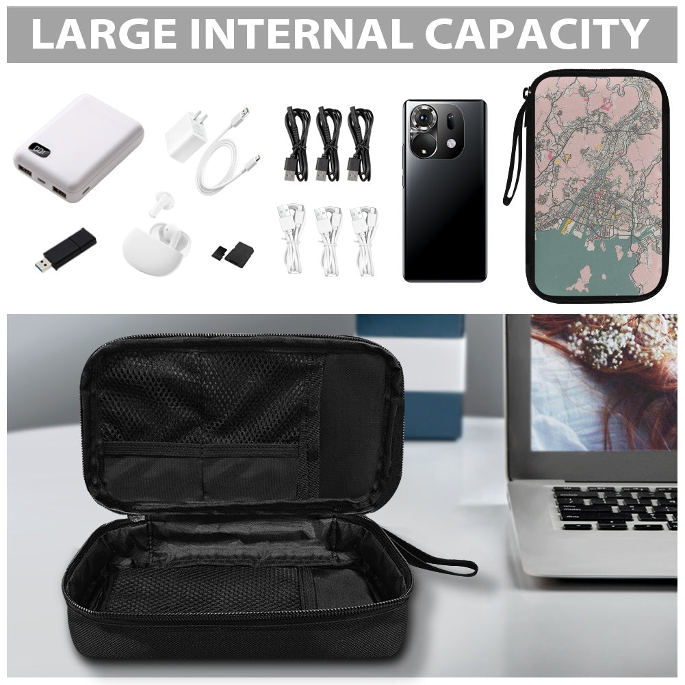 Black travel case with electronic accessories and a phone case on a table.