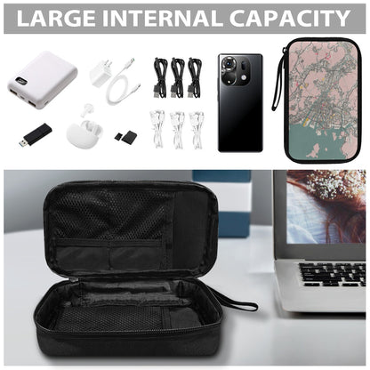 Black travel case with electronic accessories and a phone case on a table.
