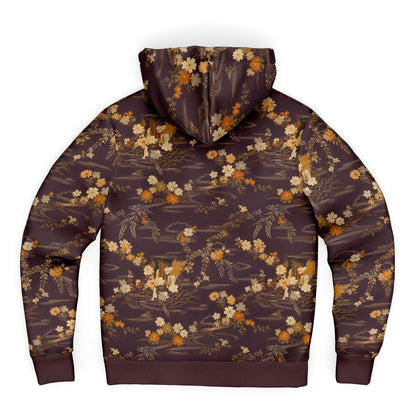 A dark brown hooded sweatshirt with a detailed all-over print of golden-brown foxes, wildflowers, and trees on a white background.