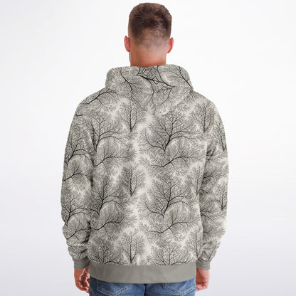 A man viewed from behind wearing a hooded sweatshirt with an all-over abstract tree branch pattern in gray and off-white, paired with blue jeans against a plain light background.