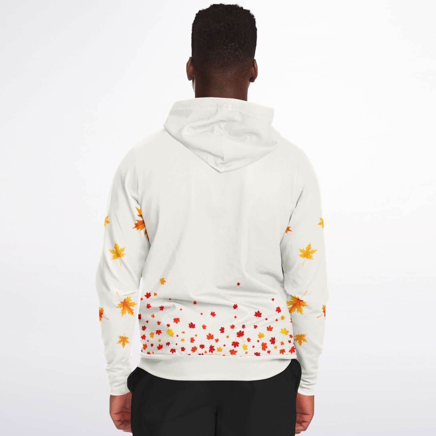 A man viewed from the back wearing a white hooded sweatshirt with an autumn maple leaf print in orange, yellow, and red, paired with black pants, against a plain white background.