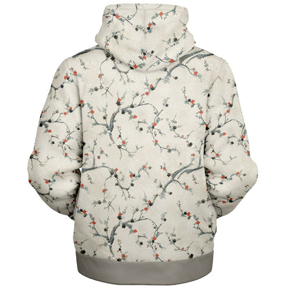 A hooded sweatshirt shown from the back, featuring an all-over cherry blossom branch print on a light cream background with gray branches and small red-orange blossoms. The bottom hem and cuffs are solid gray.
