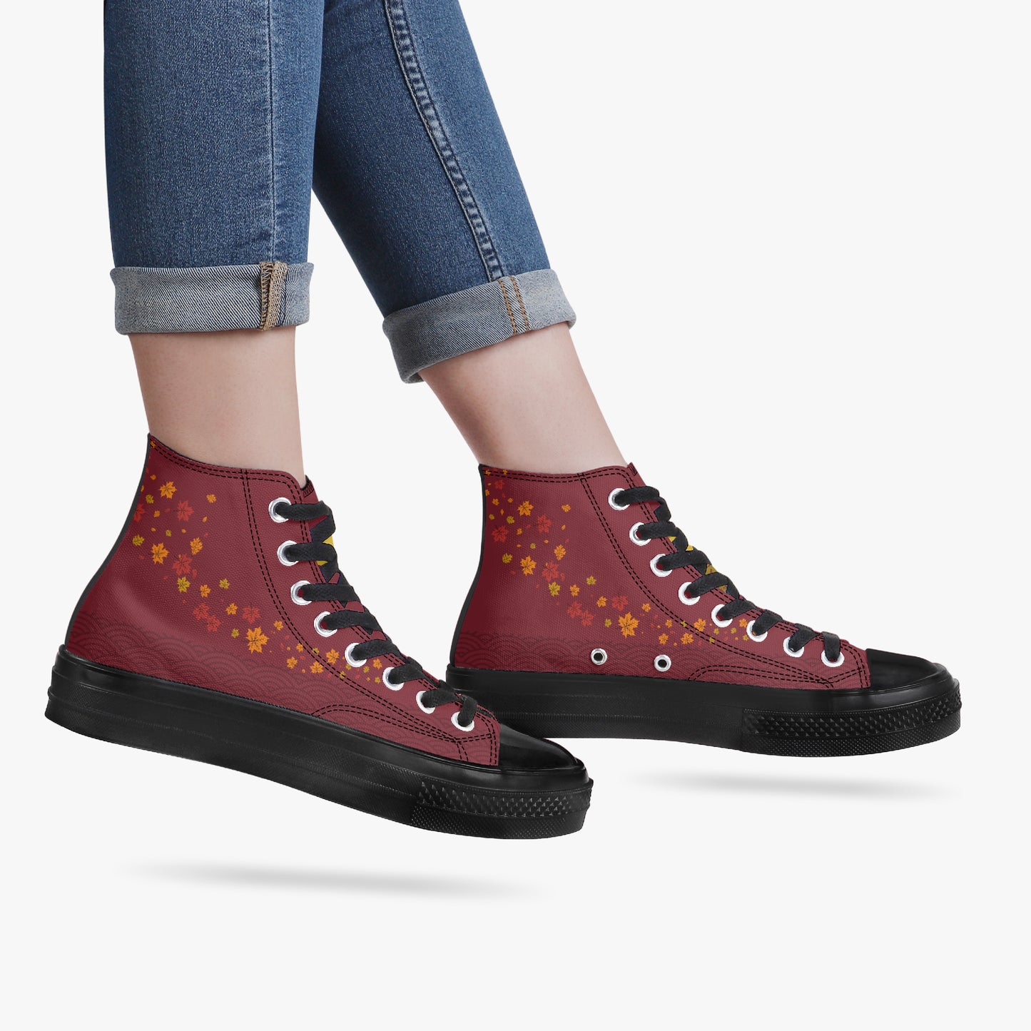 Red high-top sneakers with black soles and 'KYNDEO' branding worn with rolled-up jeans on a white background.
