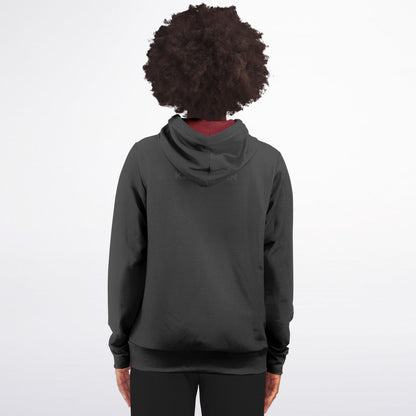 A person viewed from the back wearing a dark charcoal gray pullover hoodie with a small tonal logo on the upper back, set against a plain white studio background.