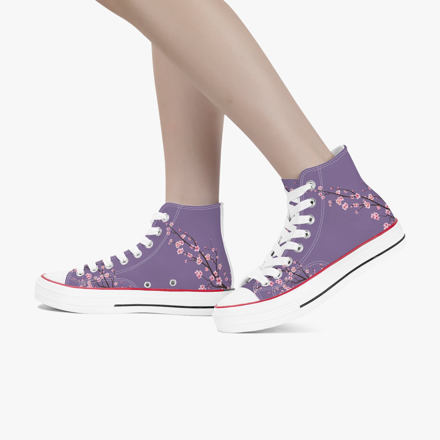 Purple high-top sneakers with floral pattern worn by a person on a white background