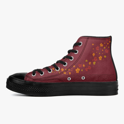A high-top sneaker with a textured burgundy canvas upper decorated with small orange and yellow maple leaves, featuring a black rubber toe cap, black laces, and a black sole, shown against a plain white background.