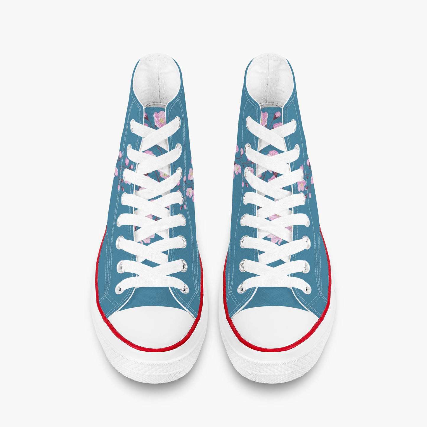 Blue sneakers with white laces and red soles on a white background