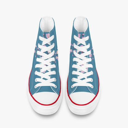 Blue sneakers with white laces and red soles on a white background