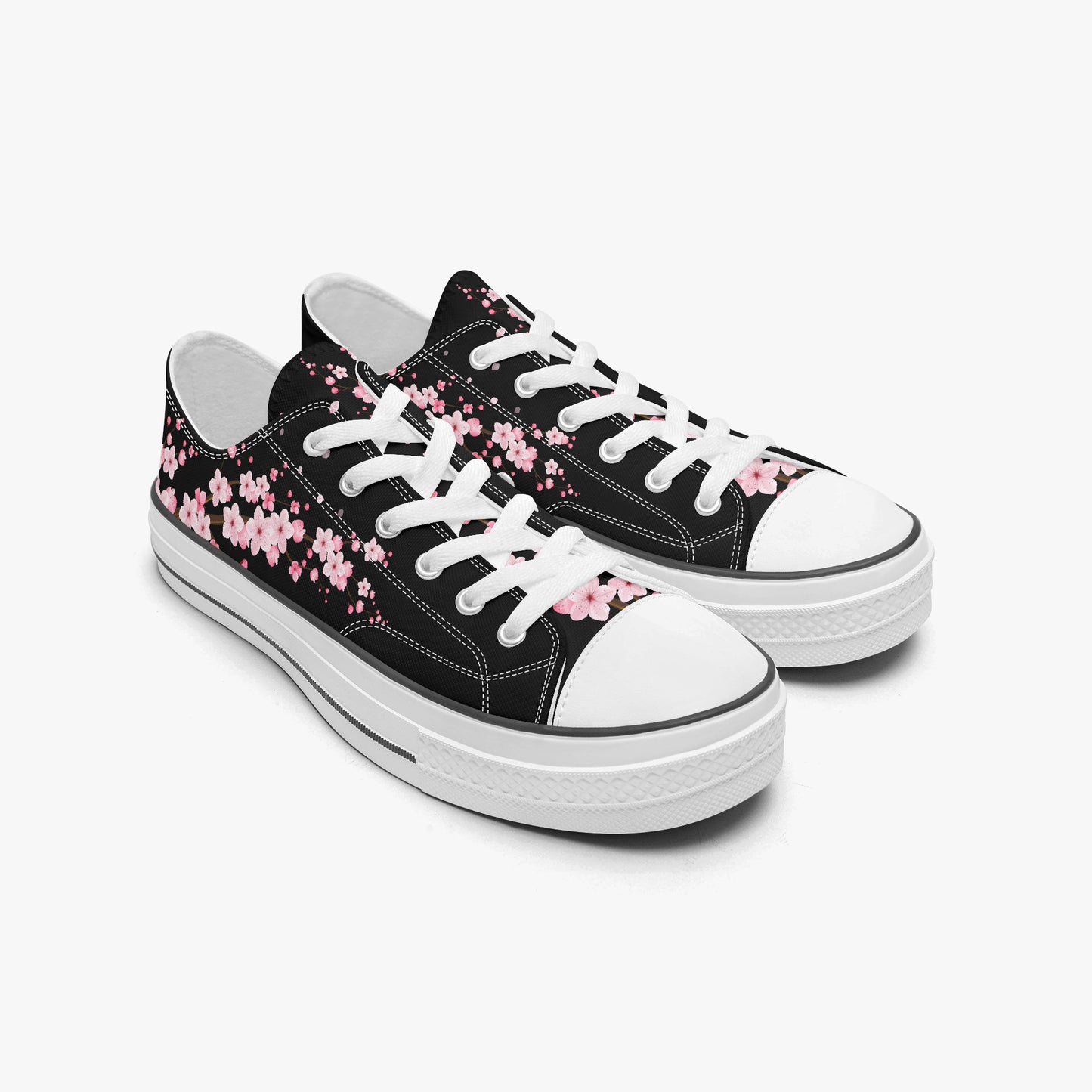 Black sneakers with pink floral patterns on a white background