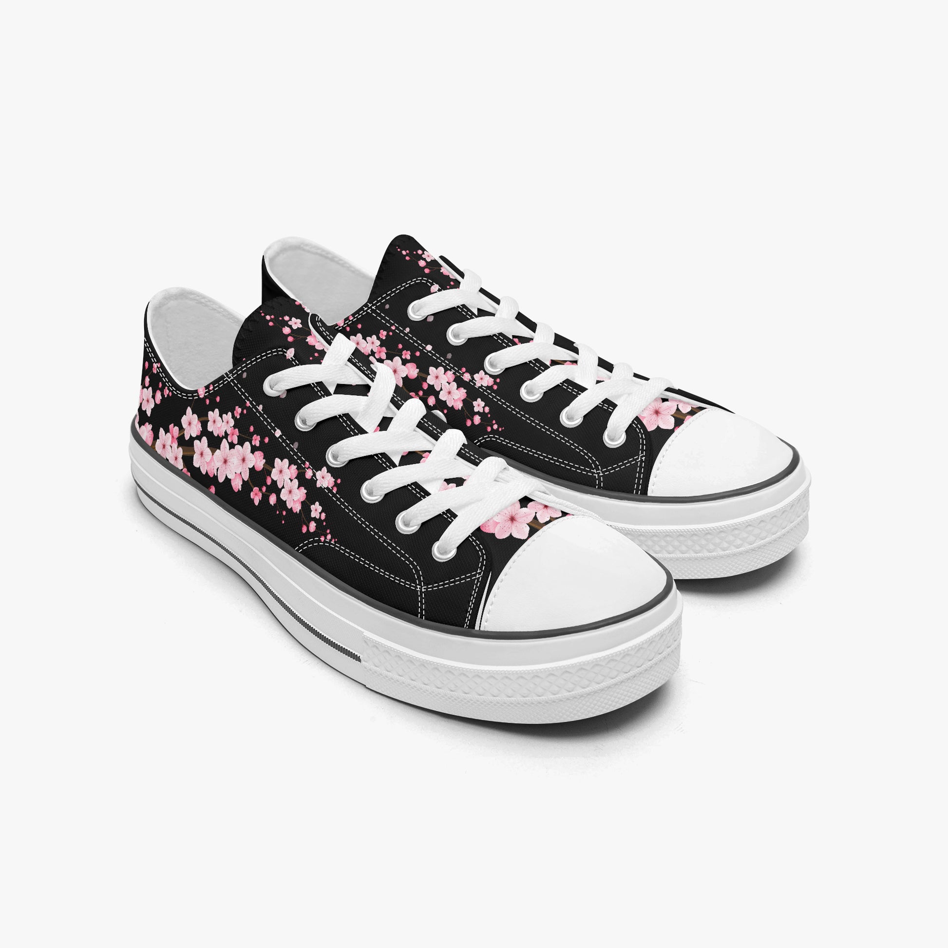 Black sneakers with pink floral patterns on a white background