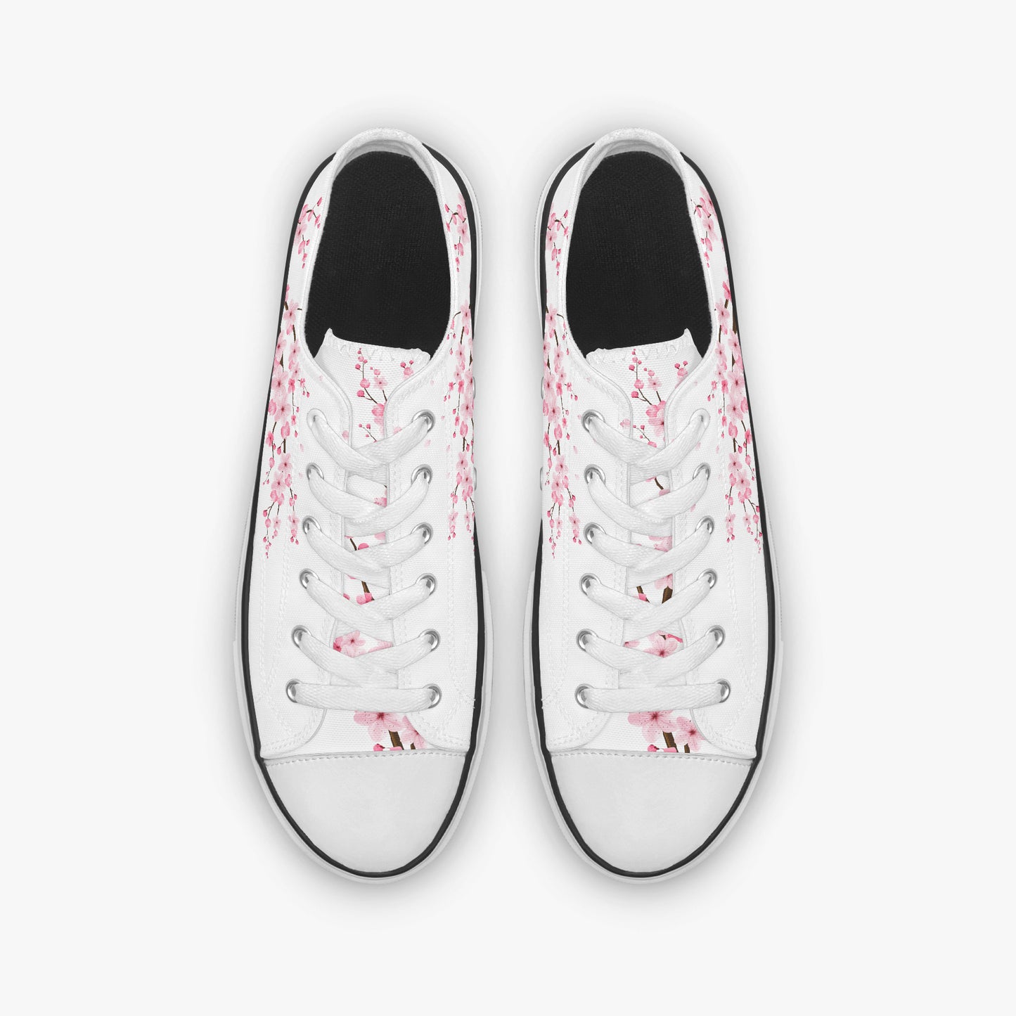 White sneakers with pink floral patterns on a white background