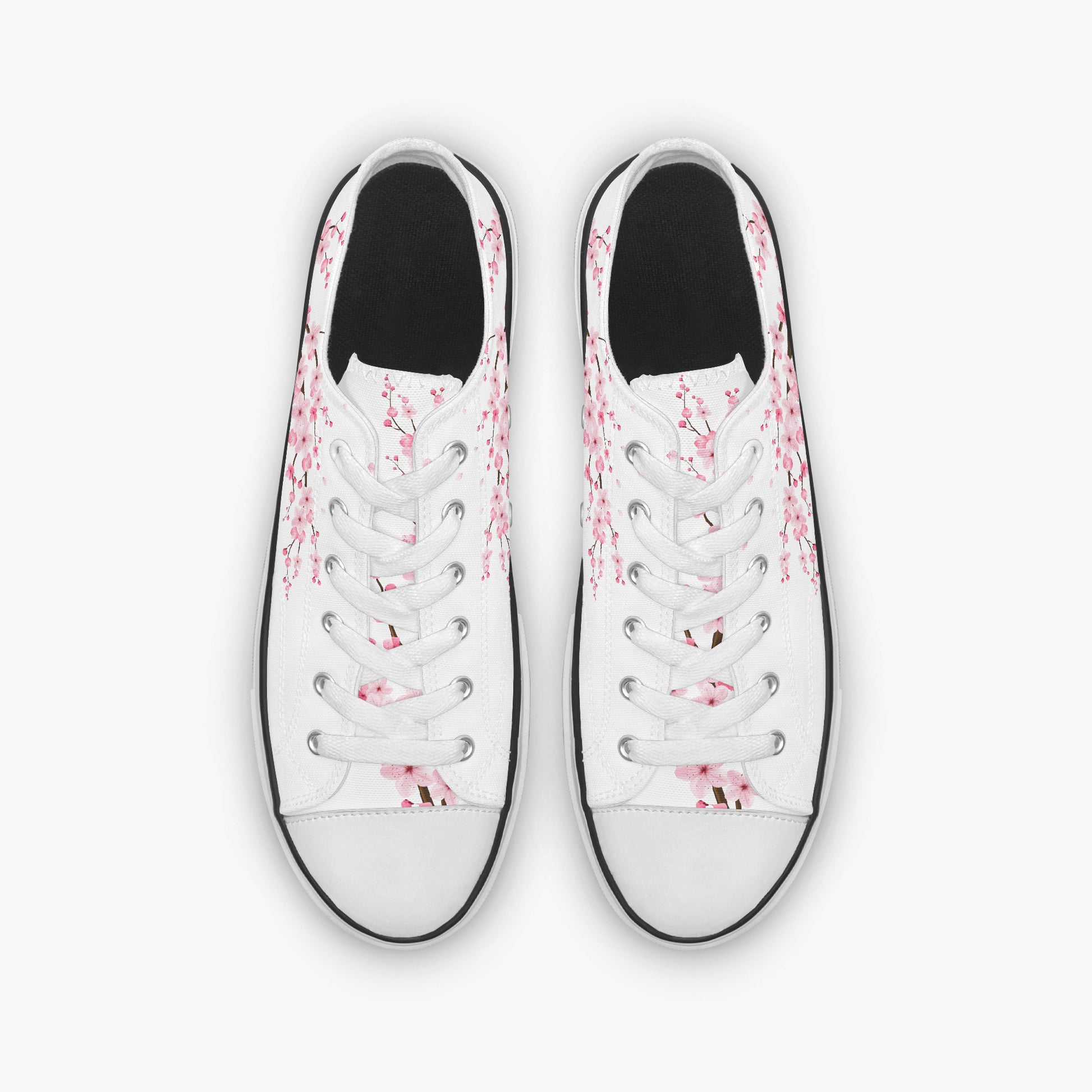 White sneakers with pink floral patterns on a white background